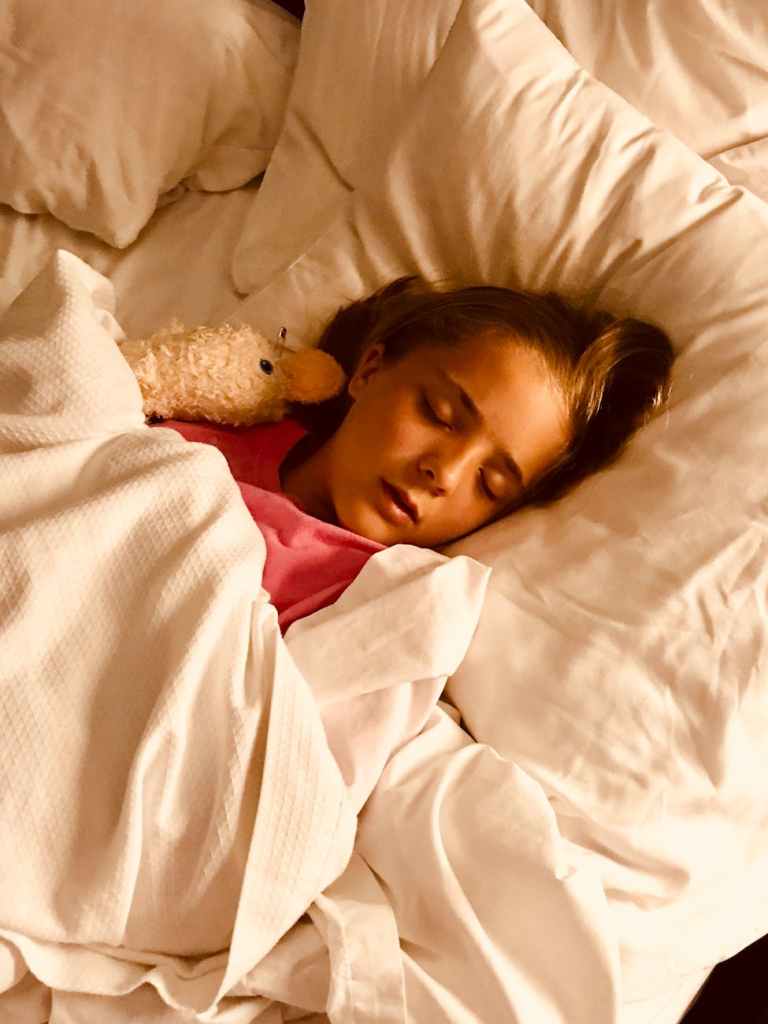 young child sleeping in bed representing sleep training for toddlers and young children