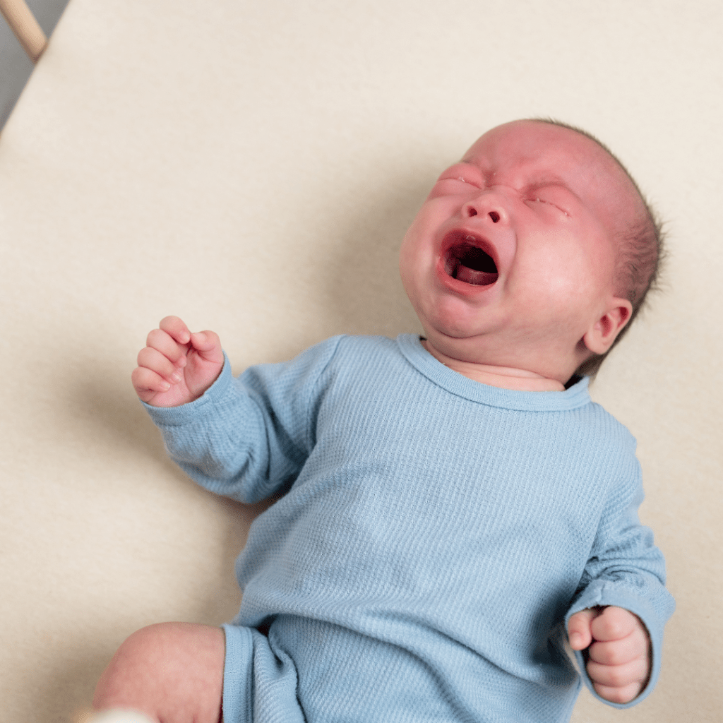 thrashing baby representing overtired cues 