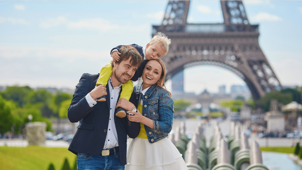 happy family in front of the eiffel tower representing better sleep for families on vacation