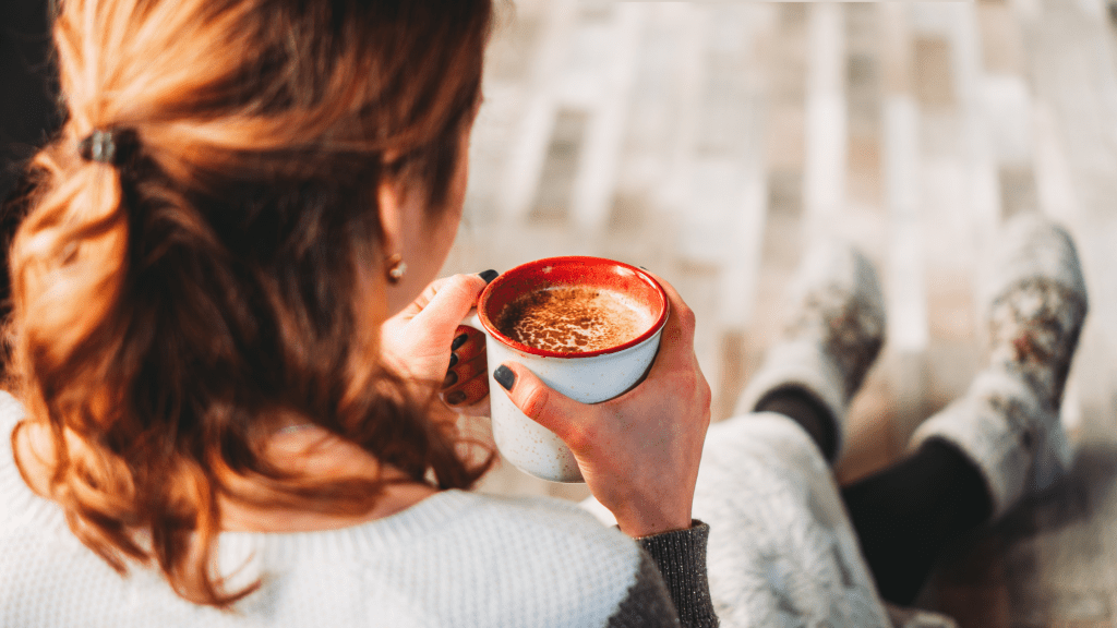 Mom drinking a hot cup of coffee representing some down time while her toddler takes a nap